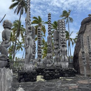 Hawaiian statues called Kii of Hawaiian deities of the past fronting a sacred temple called the Hale o Keawe in Honaunau, Hawaii Island