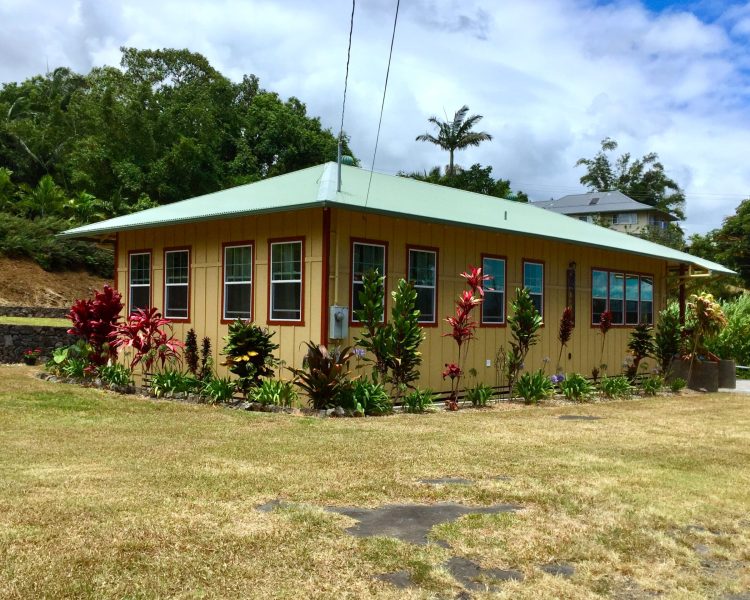 House full of Windows, yellow with green roof once used as a dance hall near Laupahoehoe, Hawaii