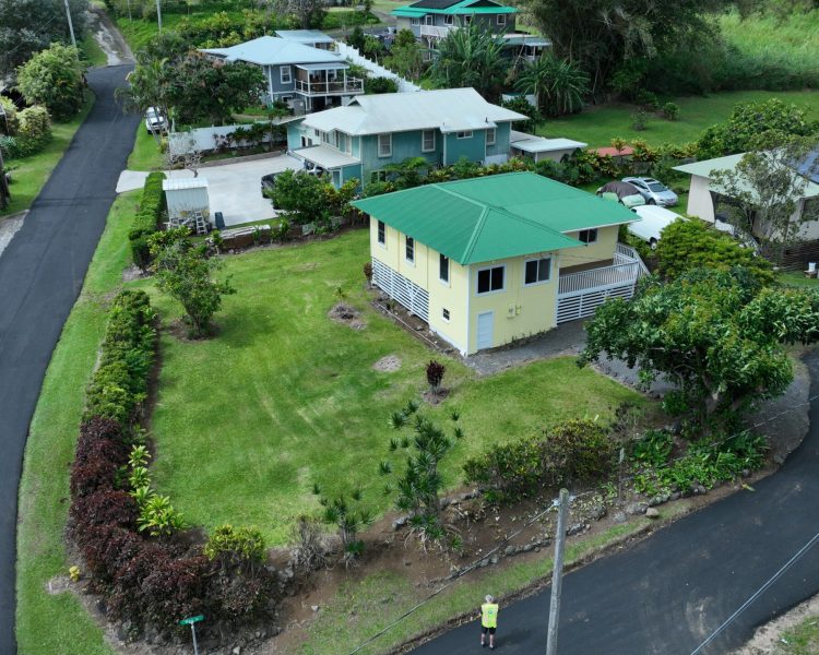 Aerial View of Yellow house with green roof in Honokaa, Hawaii